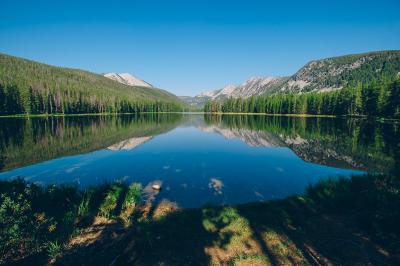 a body of water with a mountain in the background